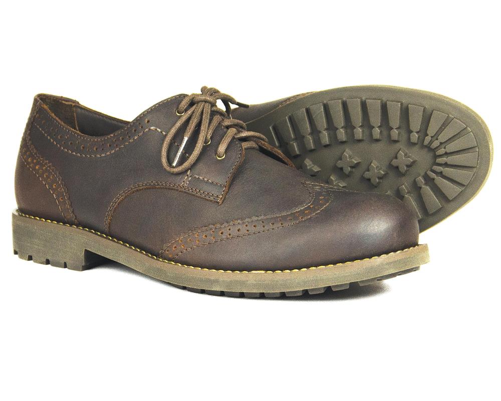 A pair of Orca Bay COUNTRY BROGUE mens dark brown leather brogue walking shoes with decorative stitching and thick, rugged rubber soles; one shoe stands upright while the other is on its side, displaying the tread pattern.
