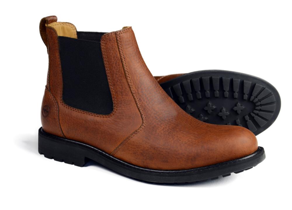 A pair of Orca Bay BRECON Men’s Brown Chelsea Boots in Havana brown leather with black elastic side panels and chunky, water-resistant rubber soles—one upright, the other on its side to show the tread.