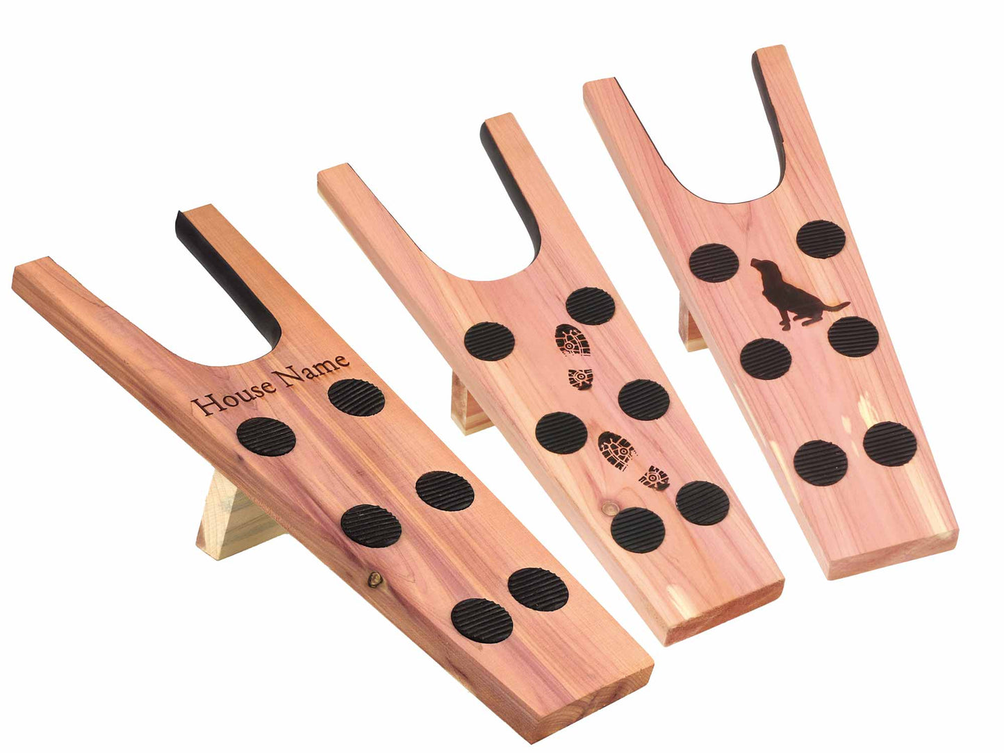 Set of three Cathcart Elliot Personalised cedar wood boot jacks (18mm thick) featuring black rubber grips: one engraved with a House Name, one with a dog silhouette, and one with boot prints. Each has a U-shaped notch and foldable leg.