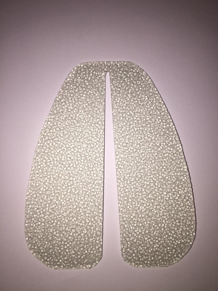 Two textured, oval Stick On Leather Sole Protectors for mens shoes by Cathcart Elliot, with a narrow gap between them, are arranged side by side on a light pink surface, resembling a pair of lungs.