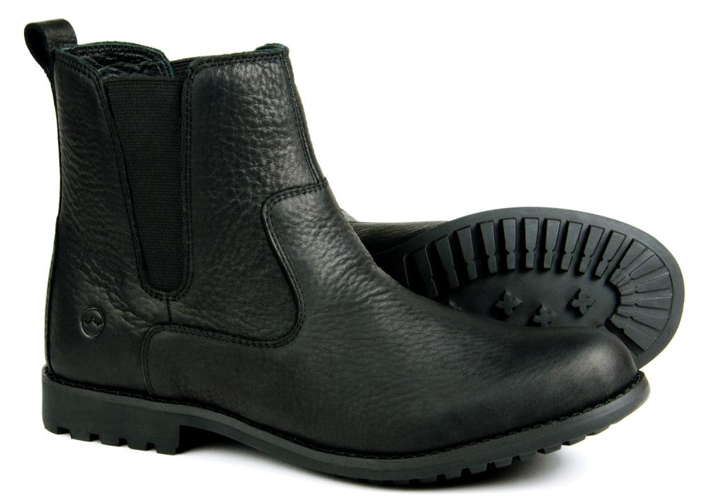 The Orca Bay Cotswold Ladies Black Leather Chelsea Boot features elastic side panels and water-resistant rubber soles—one upright, one on its side to display the tread. The perfect all-weather Chelsea boot for stylish comfort.