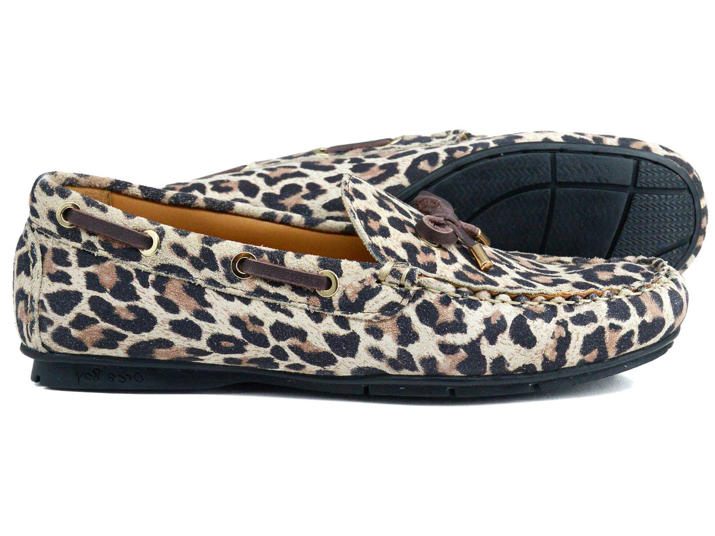 The VIENNA Ladies Leopard Suede Loafer by Orca Bay features leopard-print suede, black rubber soles, brown leather laces, and gold accents—combining the style of a driving shoe with the comfort of moccasins.
