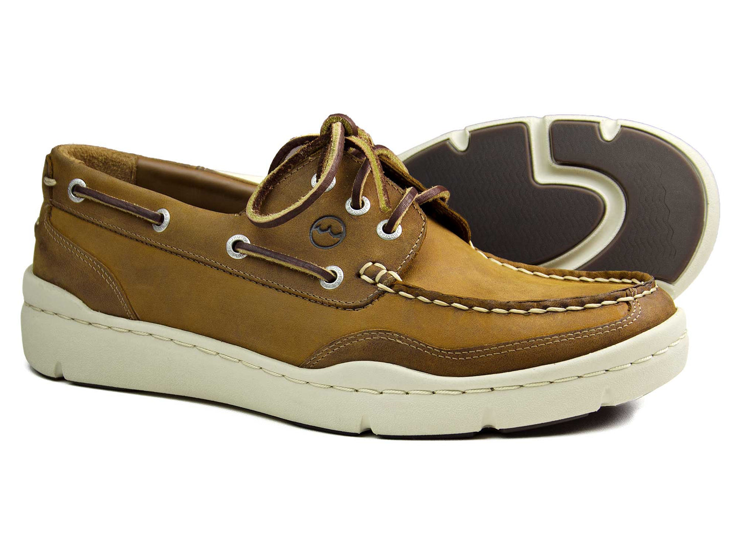 The Orca Bay ABERSOCH Mens Sand Nubuck Deck Shoe features laces, eyelets, a side logo, white stitching, and siped rubber soles for excellent grip. The lightweight EVA midsole ensures comfort, making them perfect casual shoes for on or off-water adventures.