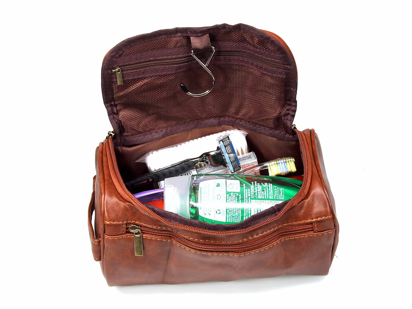 A Cathcart Elliot Brown PU leather Water Resistant Washbag with Hanger Hook is open to reveal a toothbrush, toothpaste, razor, deodorant, and hygiene products inside.