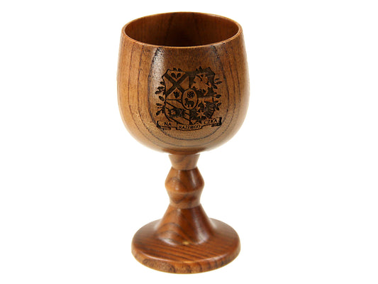 The Cathcart Elliot One Personalised Jujube Wood Wine Goblet showcases a dark engraved coat of arms and text on the bowl, with a rounded base—an ideal gift or barware piece, pictured against a white background.