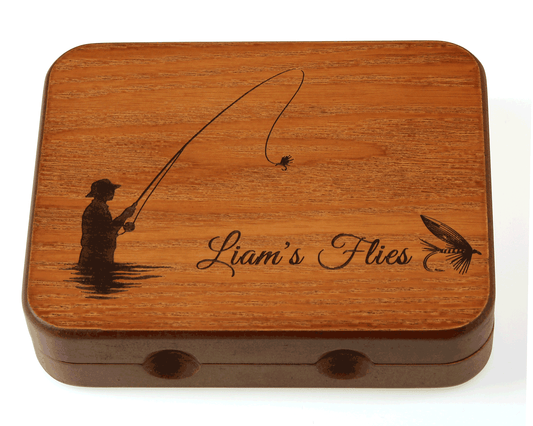 The Cathcart Elliot Personalised Wood Salmon / Trout Fly Box features a custom engraving of a person salmon fishing, a fly on the line, and “Liam’s Flies” beside a fly lure illustration.