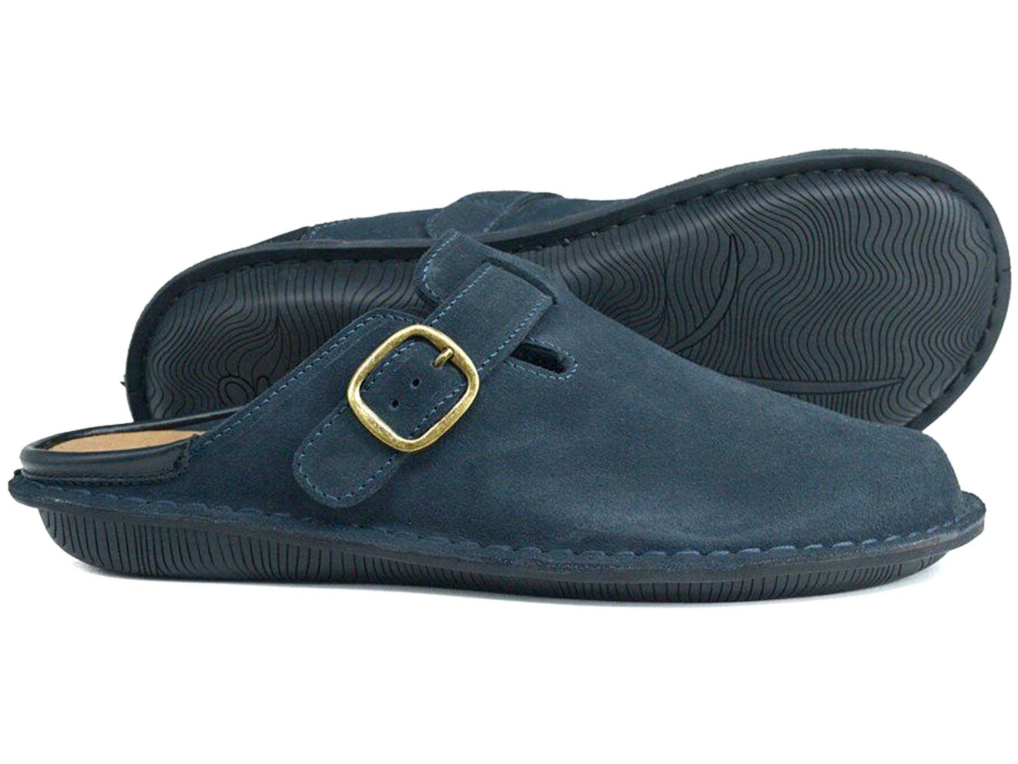 The Orca Bay Garda Navy Blue Suede Clog Mule features a unisex design with black rubber soles and a gold buckle side strap. One shoe stands upright, while the other lies on its side, showing the textured sole.