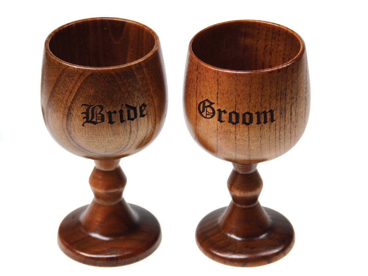 The Cathcart Elliot Engraved Jujube Wood Wine Goblet Gift from Cathcart Elliot features two polished goblets engraved with "Bride" and "Groom," a unique personalised set perfect for your special day.