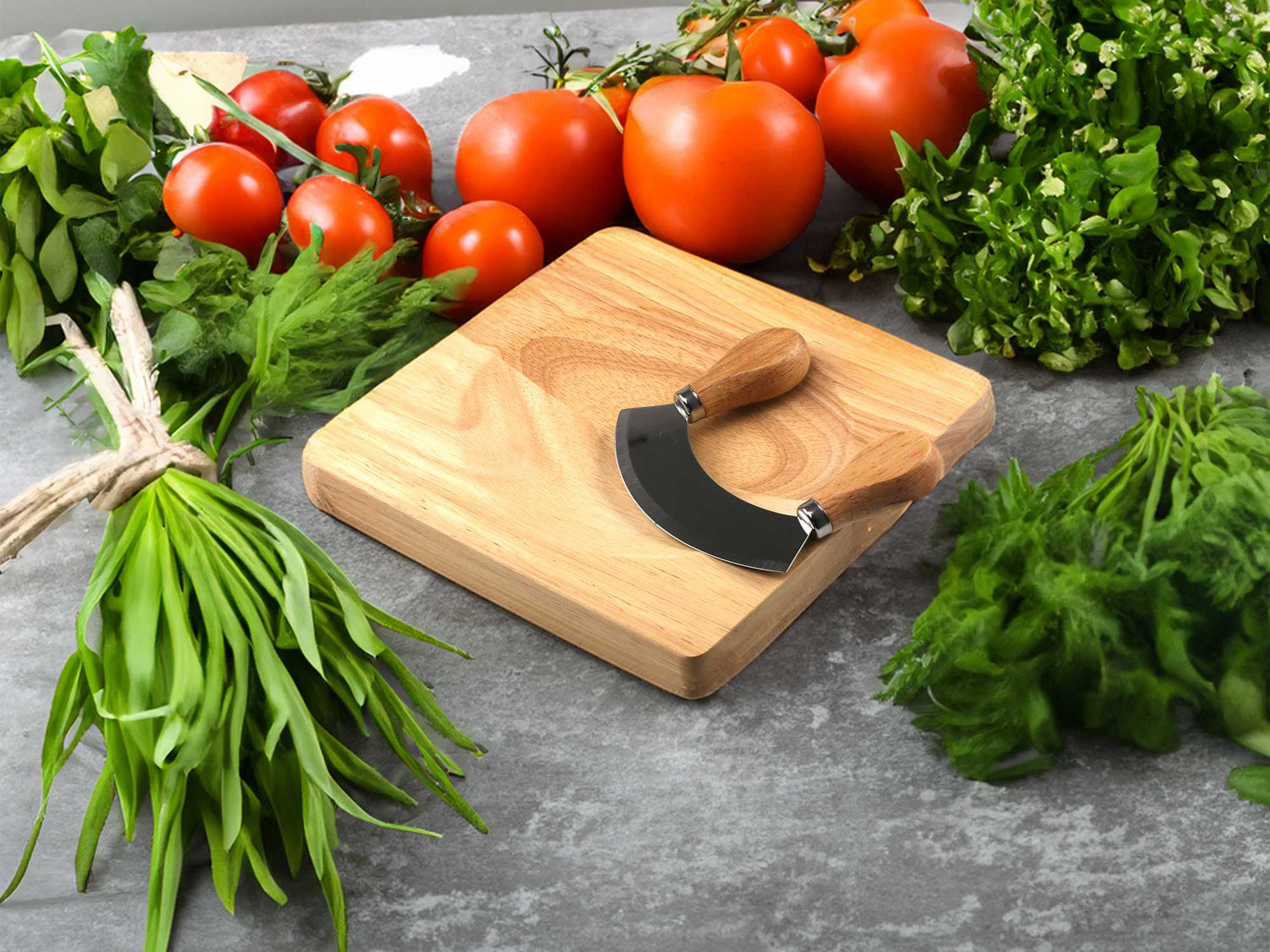 A wooden cutting board with a mezzaluna knife sits on a stone surface, surrounded by fresh herbs and vegetables. Theres a bunch of tomatoes, leafy greens, parsley, and other herbs, creating a fresh and vibrant kitchen scene.