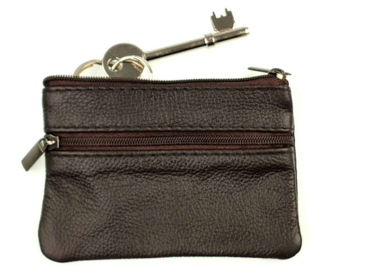 The Cathcart Elliot Brown Leather Key Coin & Card Purse Wallet features a zip closure, two compartments, and includes a set of keys with a silver key and round keyring. Resting on a plain white background, its perfect for organizing essentials with style.
