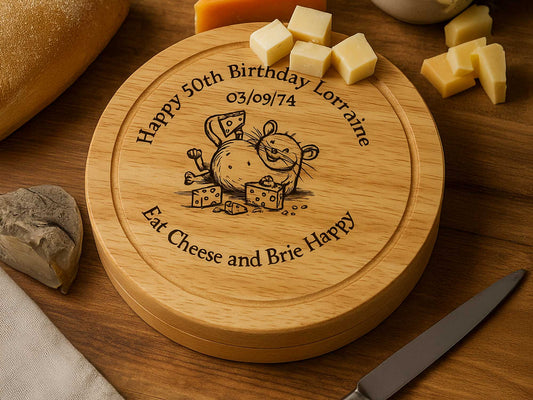 The Cathcart Elliot Mouse themed Personalised Cheeseboard Gift Set, crafted from sustainable Rubberwood and engraved with a mouse and birthday message, sits on a table alongside cheese, bread, and a knife.