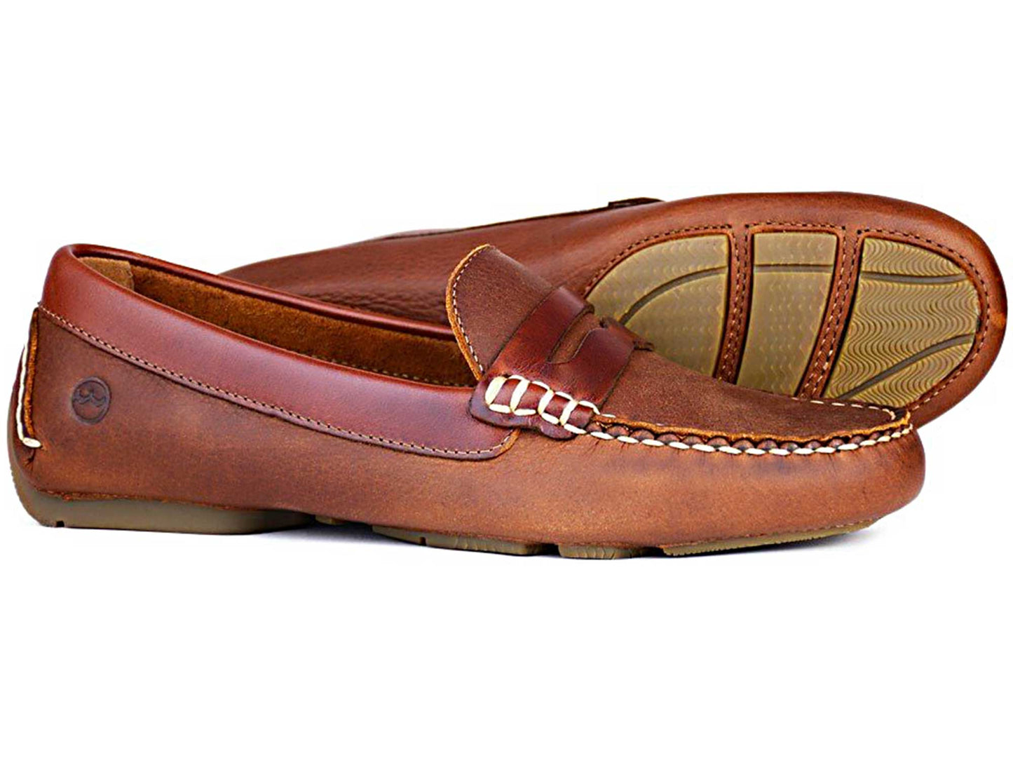 Discover the elegant RICHMOND Ladies Havana Nubuck Buckled Loafer by Orca Bay, featuring moccasin-style stitching and durable rubber soles. A chic buckle detail enhances their sophistication, with one shoe lying flat and the other showcasing its expertly crafted sole and heel.