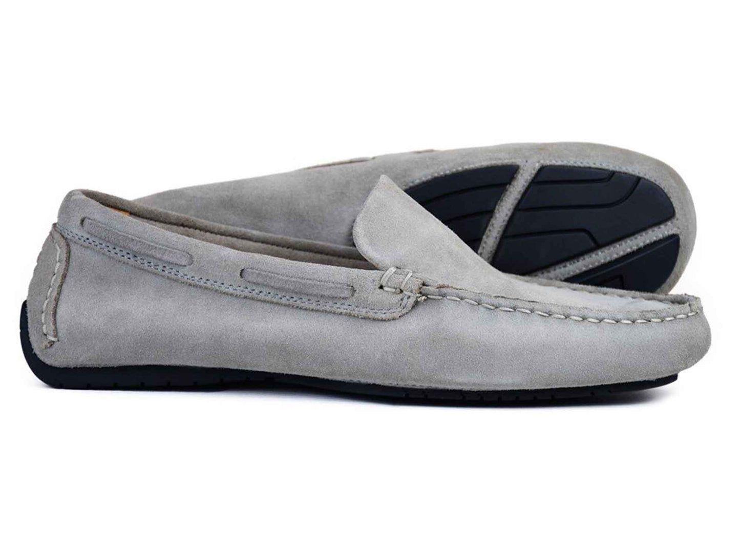 Orca Bay SILVERSTONE mens grey suede leather driving shoes—one lying flat, one angled to show the black rubber sole and visible stitching—combine classic style with comfort.