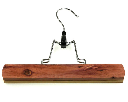 The Cathcart Elliot Deluxe trouser clamp hanger is made from cedar wood (230mm wide), featuring a metal hook and hinge. Its natural finish highlights the woods grain, while cedar provides natural moth protection.
