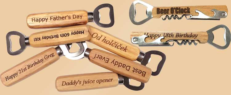 A collection of wooden-handled bottle openers with engraved messages, including Happy Fathers Day, Beer OClock, Daddys juice opener, and Happy 18th Birthday.