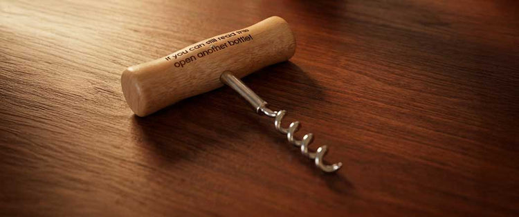 A collection of wooden-handled bottle openers with engraved messages, including Happy Fathers Day, Beer OClock, Daddys juice opener, and Happy 18th Birthday.