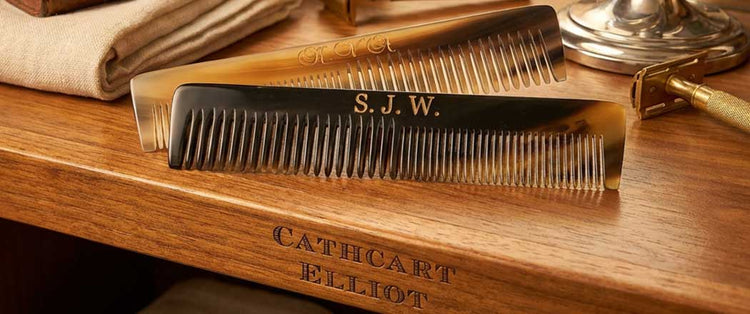 Two brown tortoiseshell combs with initials engraved on them, LVA on the top comb and SJW on the bottom comb, against a gradient beige background.