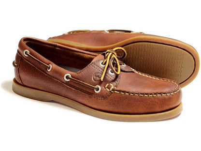 Orca Bay Creek Ladies Boat Shoe in havana full-grain leather features tan laces and rubber soles. One shoe is upright, displaying the top and side, while the other lies on its side to highlight its moccasin construction and sole.