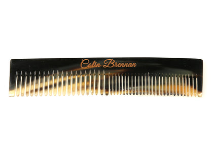 Horn comb with teeth and branding on a white background