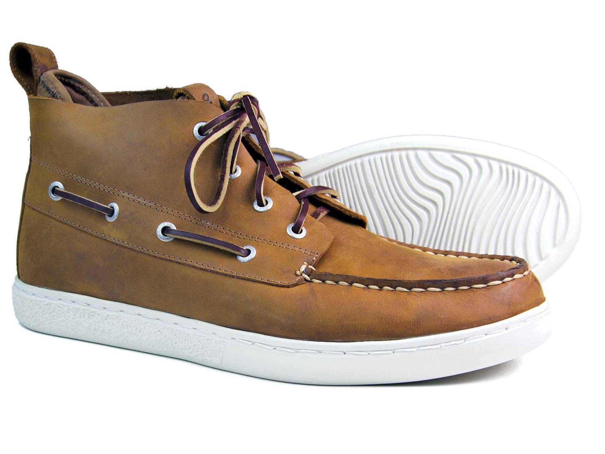 The Orca Bay Annapolis Men’s Sand Oiled Nubuck Boots feature white rubber soles, visible stitching, metal eyelets, and dark brown laces. One boot stands upright while the other lies sideways, highlighting the lightweight sole pattern.