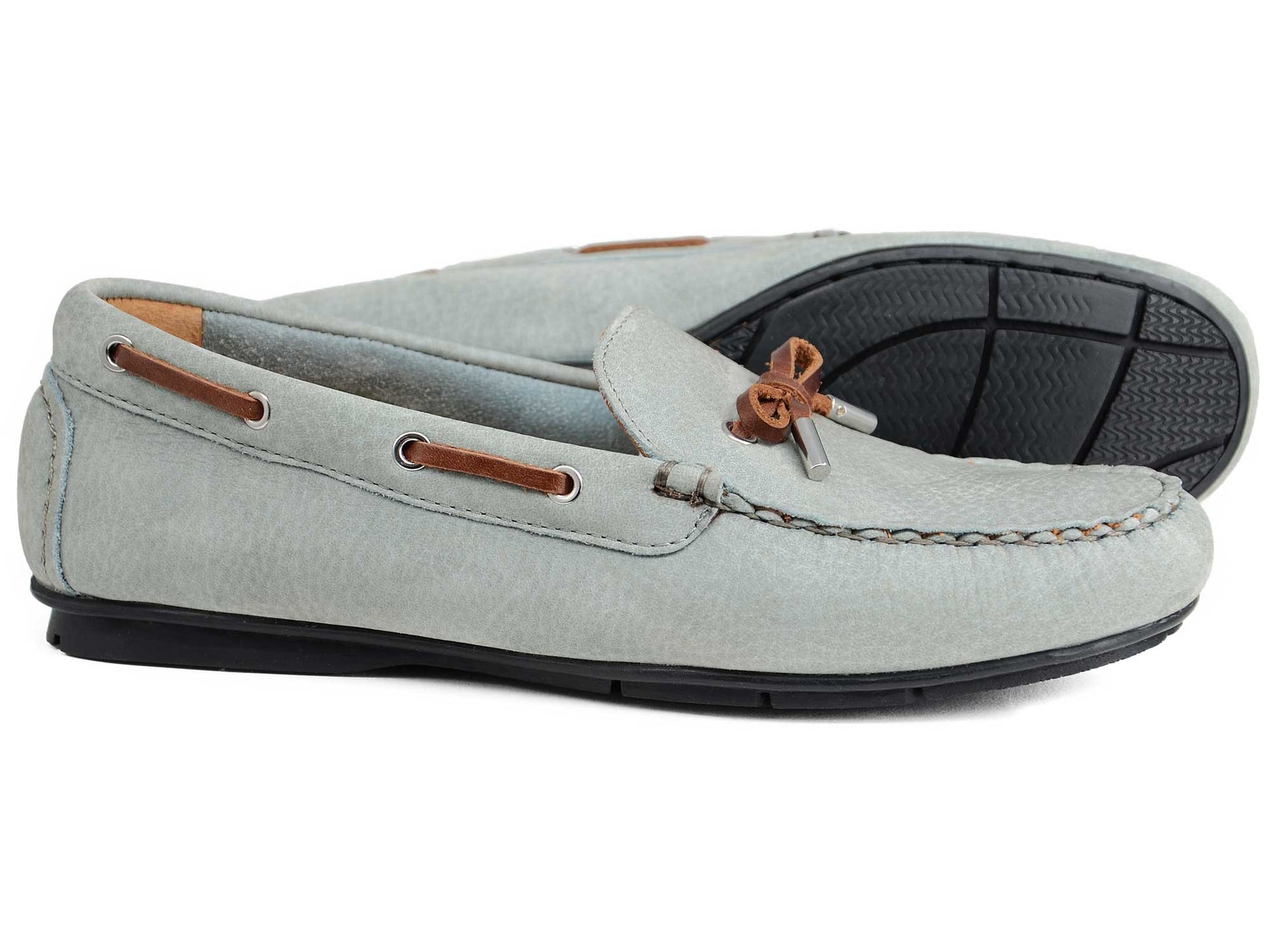A pair of Orca Bay Ladies Ballena Pale Grey Washable Nubuck Loafers, featuring brown leather laces and black rubber soles; one upright, the other on its side to display the sole.