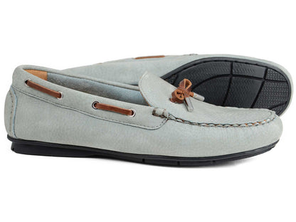 A pair of Orca Bay Ladies Ballena Pale Grey Washable Nubuck Loafers, featuring brown leather laces and black rubber soles; one upright, the other on its side to display the sole.
