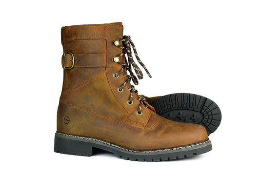 The Cathcart Elliot BODMIN Men’s Waterproof Walking Boot by Orca Bay features rugged brown leather and thick black soles, with one boot upright and the other on its side to display the tread—ideal for durable, all-weather hikes.