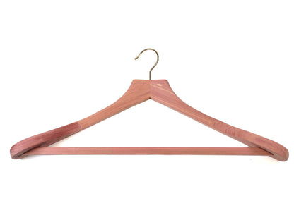 The Personalisable 48cm cedar wood suit and jacket hanger by Cathcart Elliot features a natural finish, gold metal hook, broad curved shoulders, and a horizontal bar for pants.