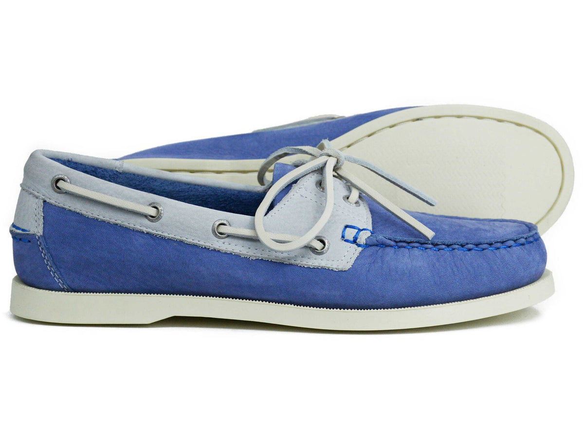 A pair of Orca Bay Ladies Sandusky Velvet Luna Blue Deck Shoes, one upright and the other on its side to showcase the sole, both displaying classic moccasin construction with white laces and stitching accents.