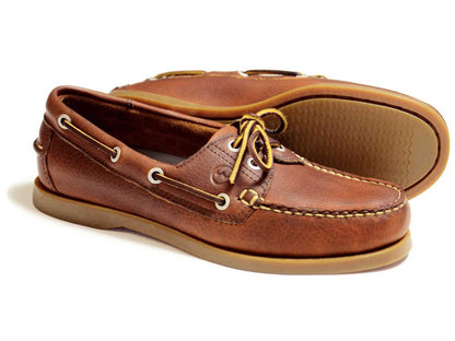 Orca Bay Creek Men’s Havana Leather Deck Shoe by Orca Bay: premium men's leather deck shoes with tan slip-resistant rubber soles and white stitching. One shoe is shown upright, revealing the top and side, while the other displays its sole.