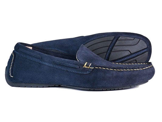 A pair of Orca Bay SILVERSTONE mens navy suede leather driving shoes with black rubber soles, visible stitching, and a moccasin-style design—one shoe stands upright while the other is on its side to show the sole.
