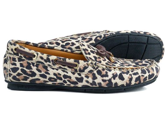 The VIENNA Ladies Leopard Suede Loafer by Orca Bay features leopard-print suede, black rubber soles, brown leather laces, and gold accents—combining the style of a driving shoe with the comfort of moccasins.