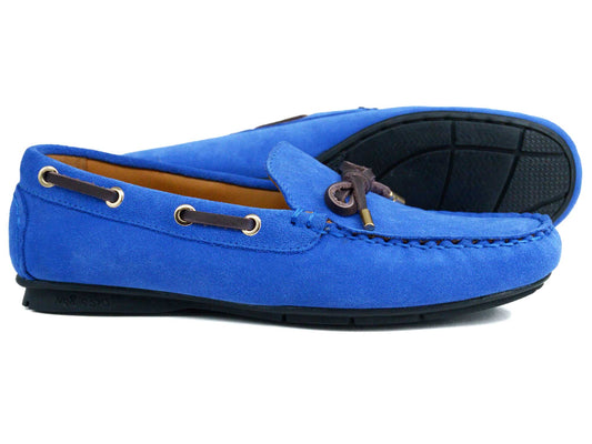 The VIENNA Ladies Nautical Blue Suede Loafer by Orca Bay features brown leather laces, contrast stitching, and black rubber soles. One shoe is shown sideways, the other behind it facing upward.