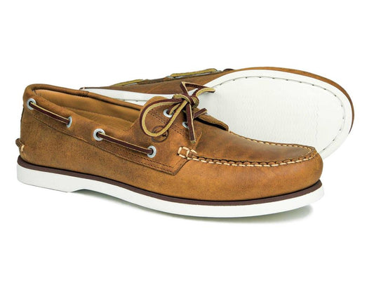 The PORTLAND Mens Orca Bay Deck Shoes in sand nubuck showcase classic moccasin-style stitching, tan laces, and white non-marking rubber soles. One shoe stands upright and the other lies on its side, revealing the soles underside.