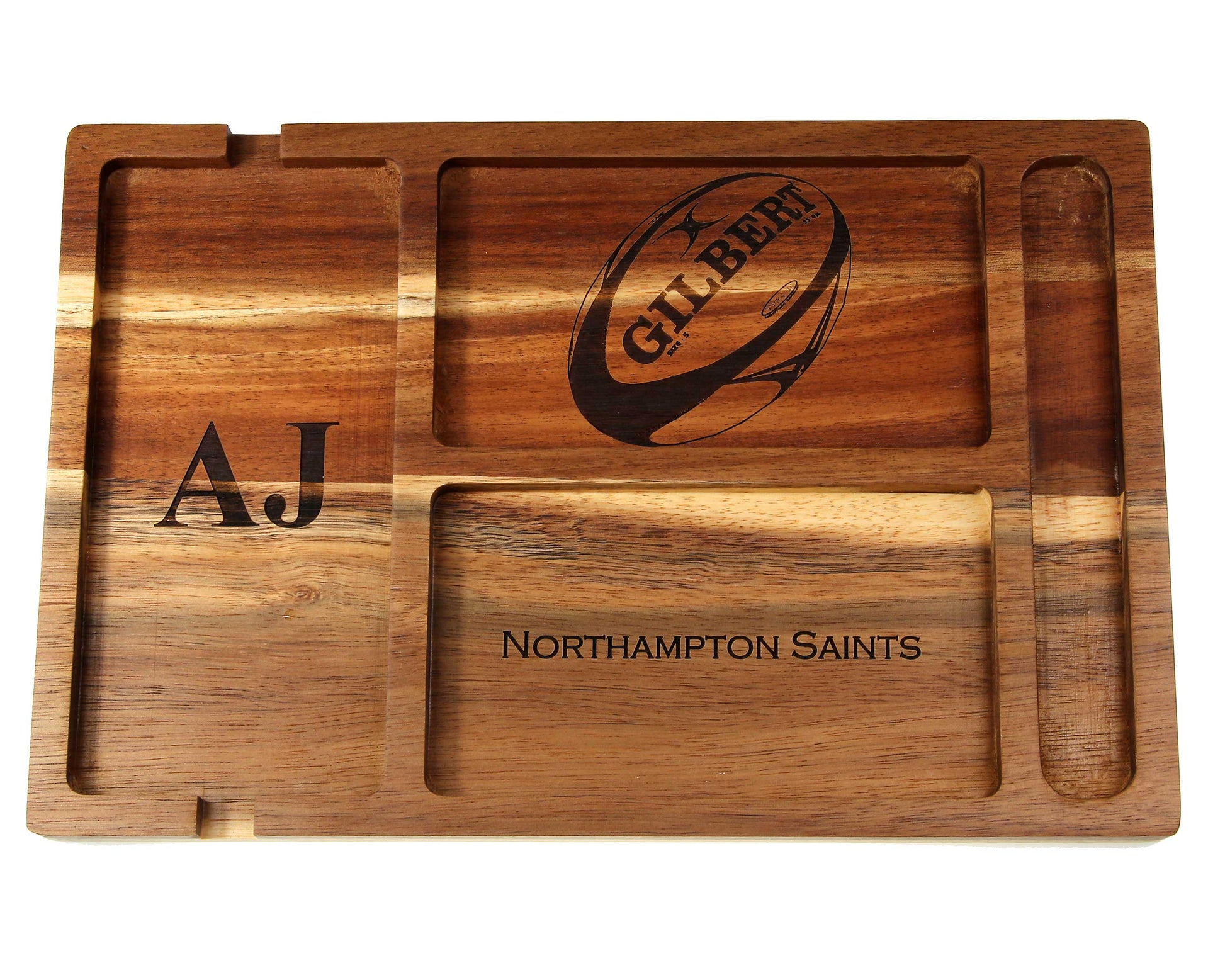 The Cathcart Elliot Personalised Acacia Wood Valet Tray for Men features four compartments and a rugby ball illustration. Engraved with the initials AJ and NORTHAMPTON SAINTS, it’s an ideal organiser for your phone, wallet, keys, and watch.