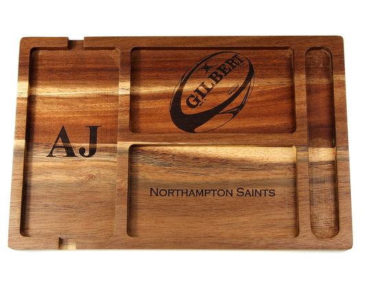 The Cathcart Elliot Personalised Acacia Wood Valet Tray for Men features four compartments and a rugby ball illustration. Engraved with the initials AJ and NORTHAMPTON SAINTS, it’s an ideal organiser for your phone, wallet, keys, and watch.