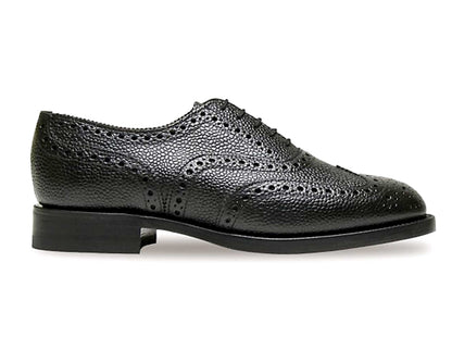 The Braemar Heavy Brogue Shoe in Black Grain Leather by Sanders features decorative perforations, a textured finish, and low heel—classic mens footwear with durable Goodyear welted construction, shown side view on a white background.