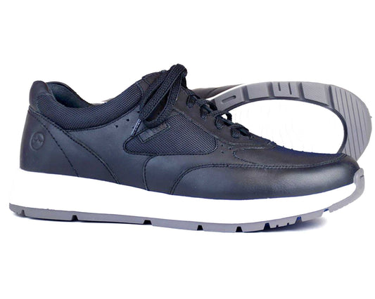 The Orca Bay CAIRNGORM Men’s Sport Shoe features a black leather and Cordura upper, white sole with gray tread, and lightweight EVA midsole; one shoe is upright while the other is on its side to show the sole.