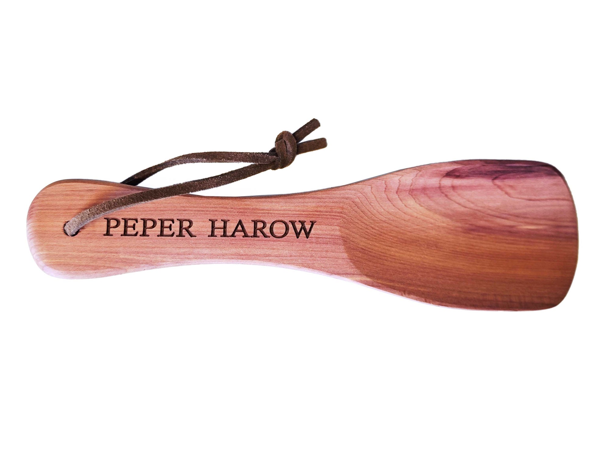 The Personalised Short Pocket Cedar Wood Shoe Horn 16cm by Cathcart Elliot features a smooth finish, custom engraving, and a brown leather loop through the handle for easy hanging. Crafted from quality cedar wood.