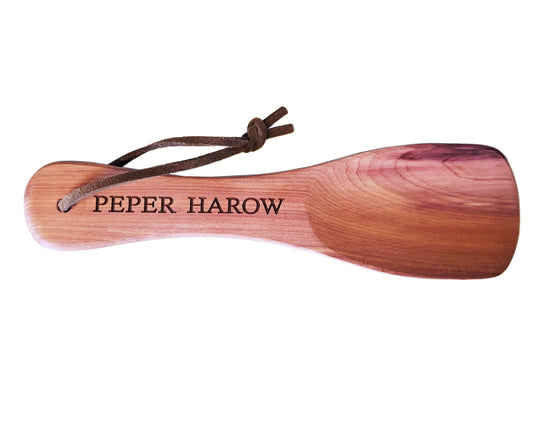 The Personalised Short Pocket Cedar Wood Shoe Horn 16cm by Cathcart Elliot features a smooth finish, custom engraving, and a brown leather loop through the handle for easy hanging. Crafted from quality cedar wood.