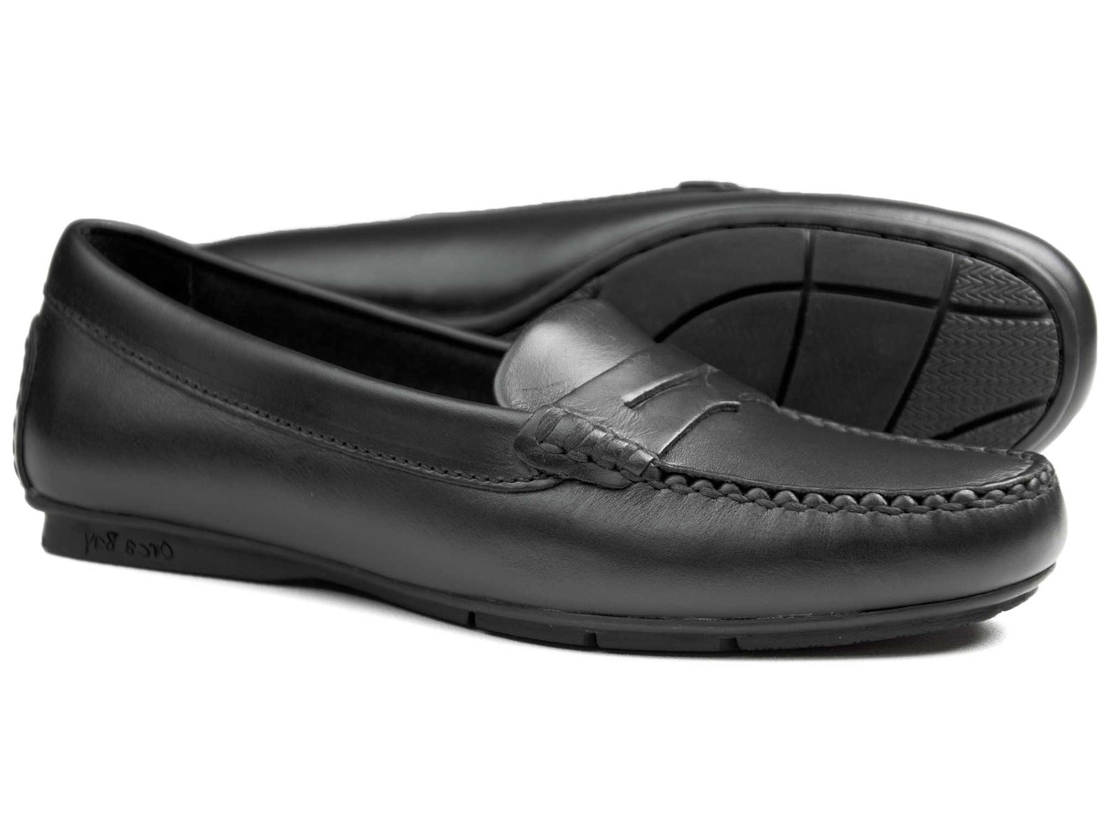 The FLORENCE Ladies Black Calf Loafer by Orca Bay offers a sleek, classic design with black leather uppers, stitching detail, and rubber soles. The slip-on style and subtle seam make them ideal driving shoes for any occasion.