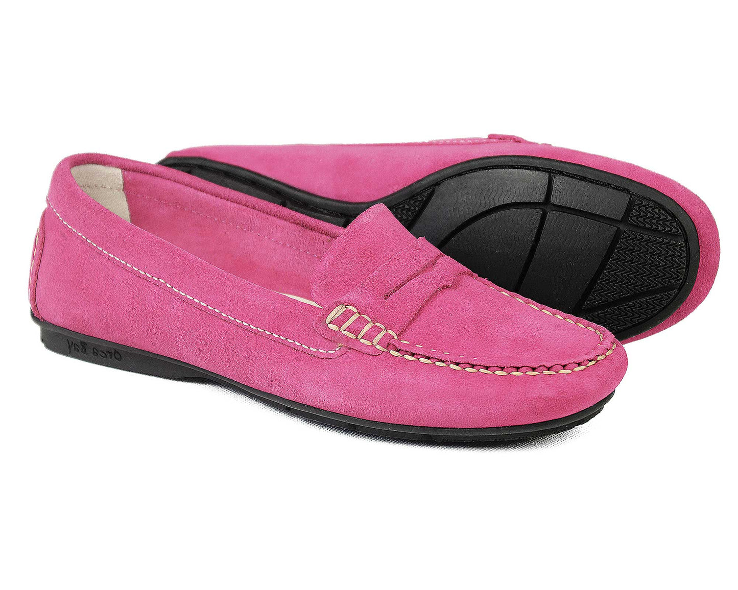 The FLORENCE Ladies Pink Suede Summer Loafers by Orca Bay feature decorative stitching and black rubber soles. Displayed side by side with one shoe angled, they highlight their elegant moccasin construction.