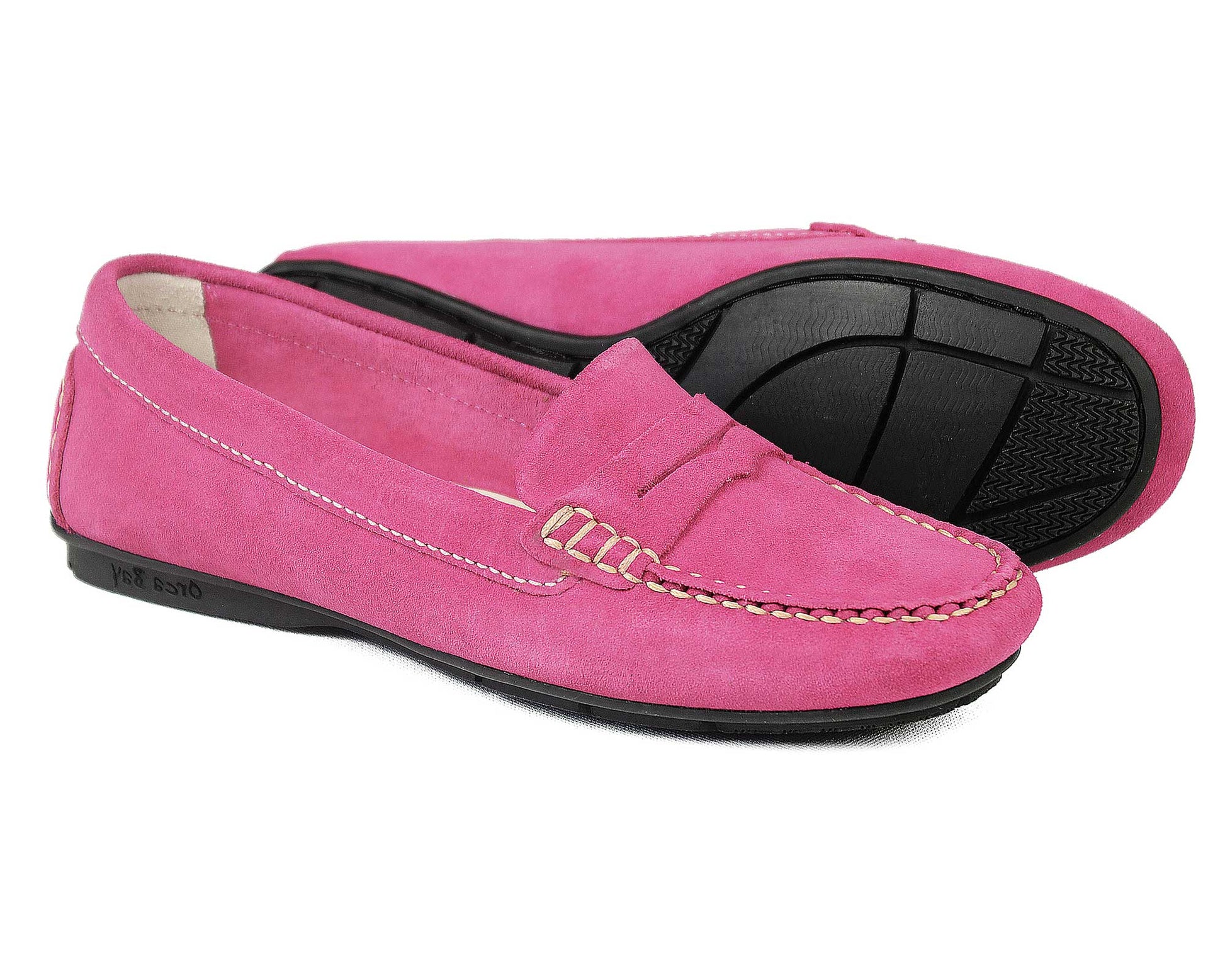 The FLORENCE Ladies Pink Suede Summer Loafers by Orca Bay feature decorative stitching and black rubber soles. Displayed side by side with one shoe angled, they highlight their elegant moccasin construction.