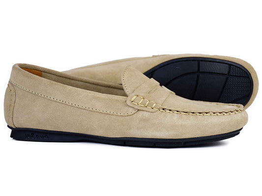 The FLORENCE Ladies Taupe Suede Summer Loafer by Orca Bay features stitching details and a black rubber sole, with one shoe upright and one on its side—an ideal choice for effortless summer style.