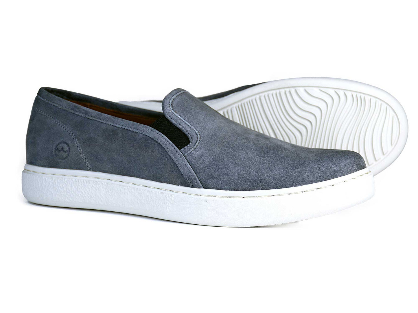 The FULHAM Mens Grey Loafers by Orca Bay are sleek slip-ons with a white shock-absorbing sole, a subtle side logo, and a textured wavy pattern underneath.