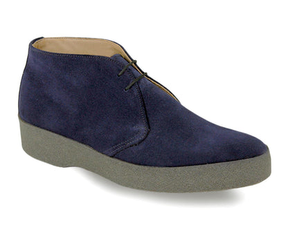 The HI TOP Mens Navy Suede Chukka Boot by Sanders features a classic design with a navy suede upper, two lace eyelets, gray crepe rubber sole, and visible edge stitching, embodying a style fit for James Bond movies.