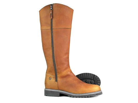 The SALE IONA Ladies Light Brown Havana Leather Country Boot by Orca Bay flaunts a water-resistant finish, a black vertical zipper, and a rugged sole with visible tread. Its slightly turned second boot reveals the intricate sole pattern alongside the comfort of a cushioned footbed.