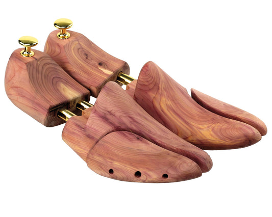 The Personalisable Superior English Lasted Cedar Wood Shoe Trees by Cathcart Elliot are crafted from aromatic cedar and have brass knobs. They feature adjustable spring mechanisms for length and width, with three ventilation holes at the toes to enhance both function and form in footwear care.