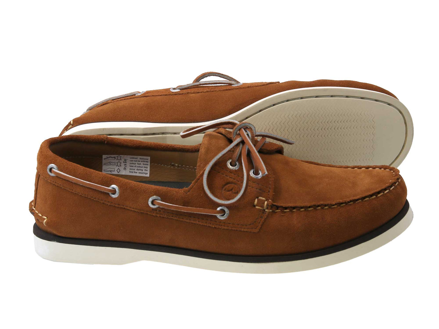 A pair of PORTLAND Cinnamon Brown Suede Boat Shoes from Cathcart Elliot features white soles, silver eyelets, and brown laces. One shoe is placed on its side to reveal the sleek sole, while the other stands upright.