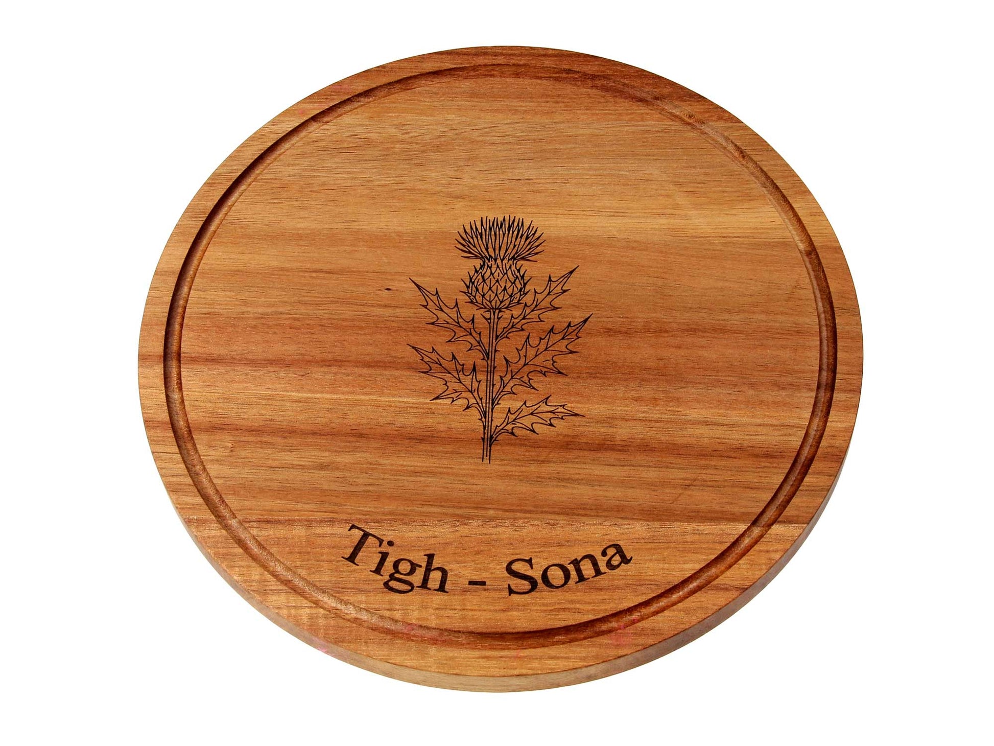 The Cathcart Elliot Personalised Round Acacia Wood Cheese and Cutting Board (25cm x 1.5cm) features a carved thistle and "Tigh - Sona" engraving—ideal as a unique serving board or sustainable cheese platter.